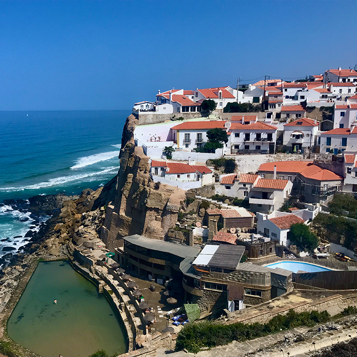 Whitewashed coastal village perched above the ocean
