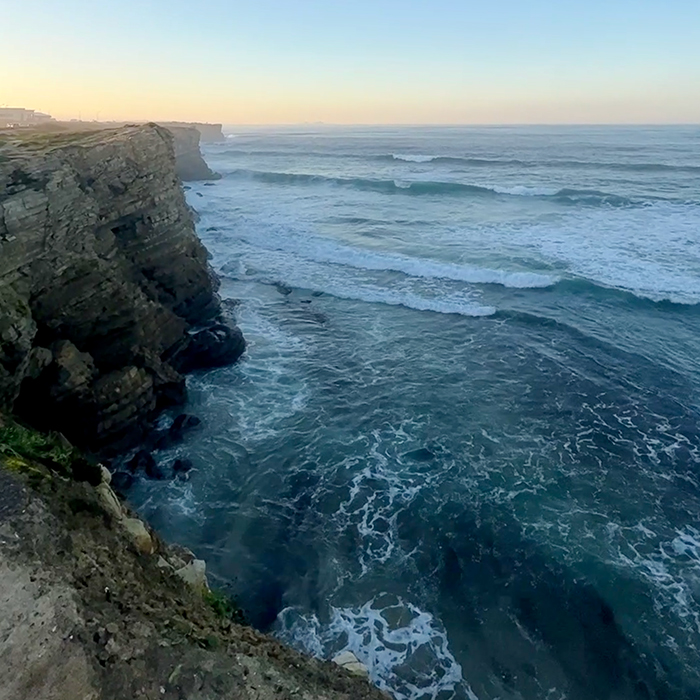 Atlantic waves breaking beneath rugged coastal cliffs