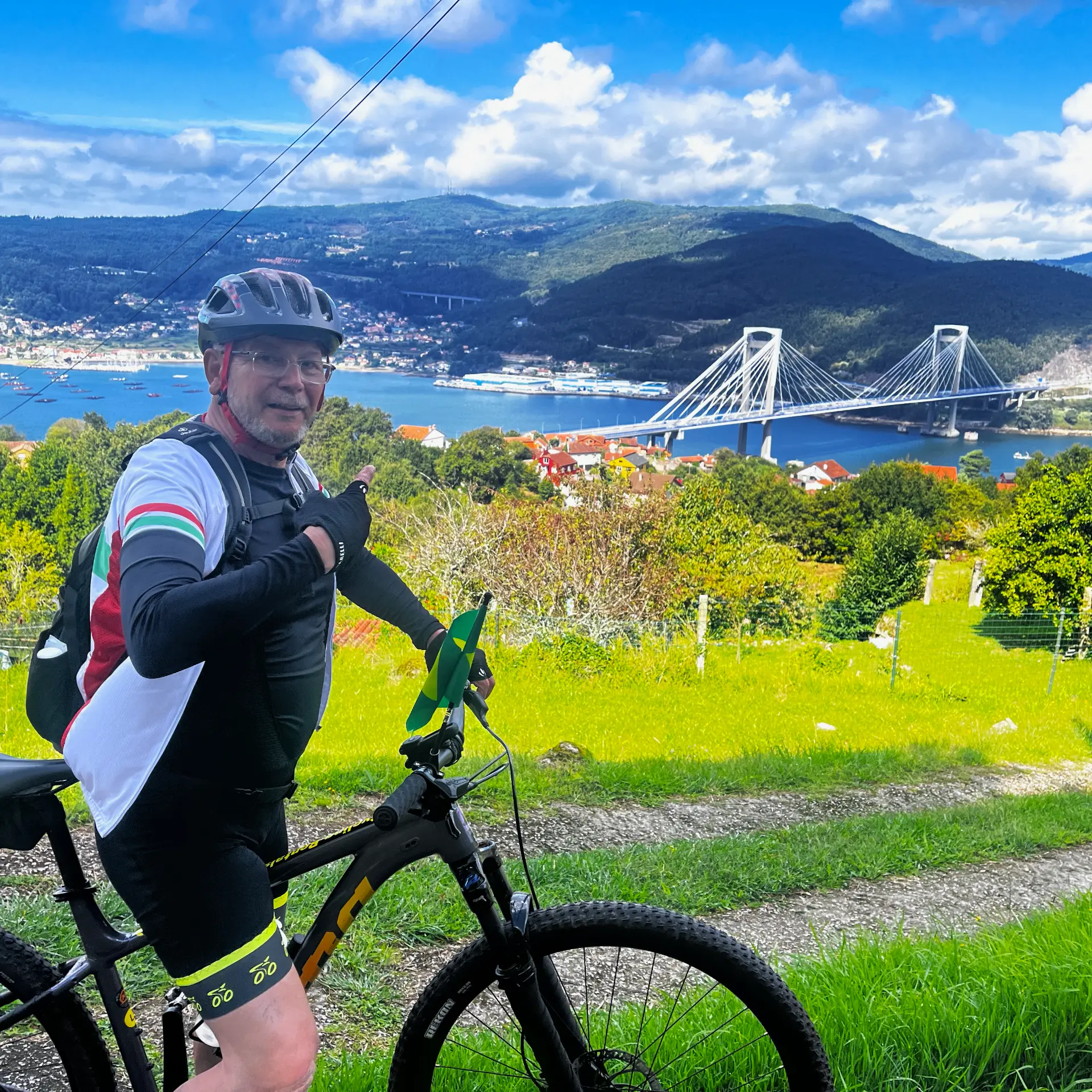 Cyclist overlooking a coastal bridge on the route to Santiago