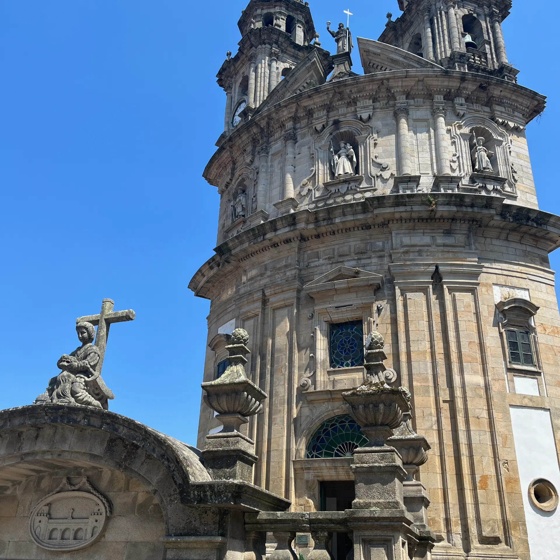 Historic church tower along the Camino beneath a clear blue sky