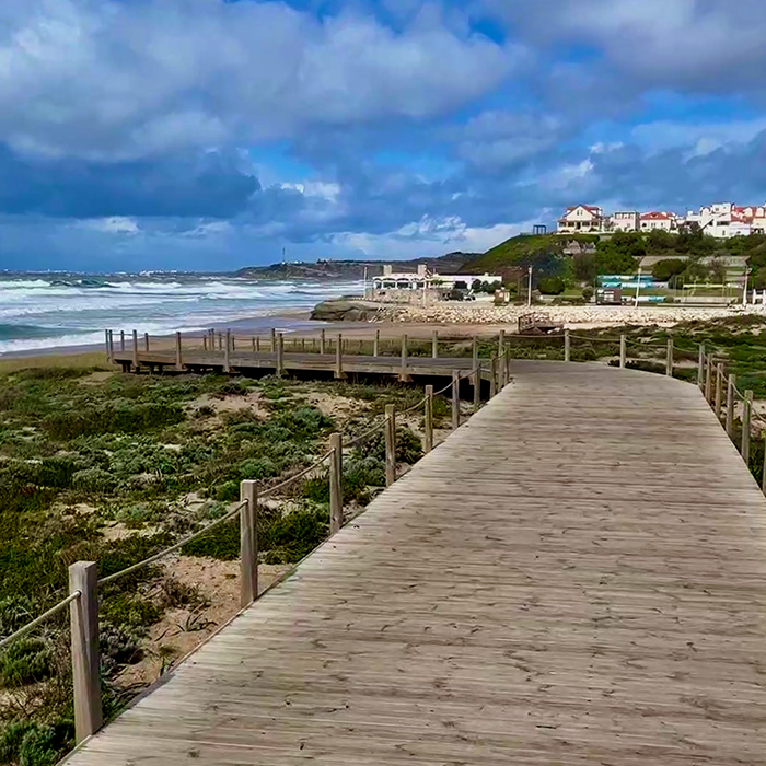 Wooden boardwalk leading through dunes toward the Atlantic